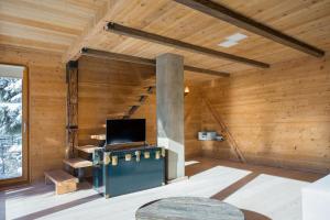 an empty room with a fireplace in a wooden house at Kostovac Boutique Homes - House 1 in Kopaonik