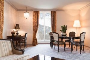 a dining room with a table and chairs at Carlton Hotel St Moritz - The Leading Hotels of the World in St. Moritz