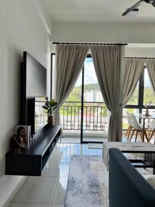 a living room with a couch and a large window at Lily Ville in Tanah Rata
