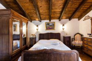 a bedroom with a large bed with a wooden ceiling at Holiday Home Casa Country in Zadvarje +26 photos