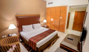A bed or beds in a room at Xclusive Hotel Apartments