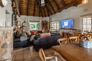 a living room with a couch and a table at 30 Mimosa in Mtunzini