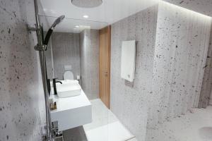 a bathroom with a sink and a mirror at HOTEL 12 in Gjakove +40 photos