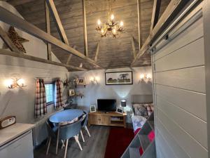 a tiny house with a desk and a bedroom at Luxury Woodland Lodge in Newport Pagnell
