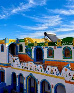 a building with a painting on the side of it at Kato Dool Wellness Resort in Aswan