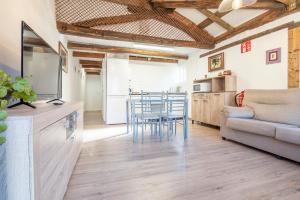 a kitchen and living room with a couch and a table at Casa Rafa in Buellas