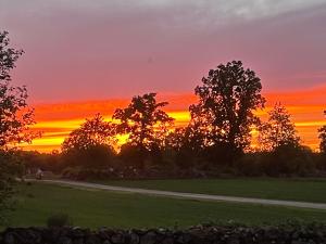 The sunrise or sunset as seen from a panziókat or nearby