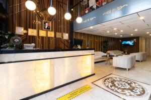 a lobby with a reception counter and a restaurant at Leslion Luxury Hotel in Antalya