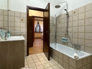 a bathroom with a tub and a shower and a sink at Due Carrare Business in Due Carrare