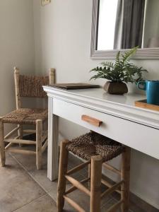 a desk with a potted plant and two chairs at Conny's Hotel (Adult Only) +18 in Side