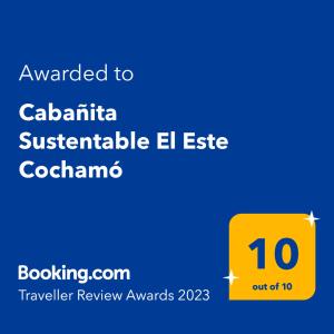a yellow sign with the text awarded to calabria sustainable el estate coordinator at Cabañita Sustentable El Este Cochamó in Cochamó