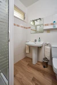 a bathroom with a sink and a toilet at Las Sabinas Playa - El Guincho, Garachico in Garachico