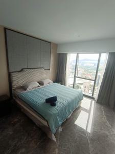 a bedroom with a black cat laying on a bed at Platinum 2 KLCC NewLuxuryCondo By Langitel with InfinityCityView SwimmingPool in Kuala Lumpur