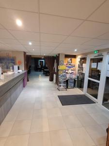 a store aisle with a counter in a store at Hôtel Le Cosy Blois Villebarou in Blois