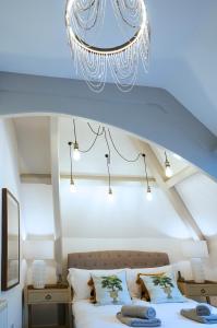 a bedroom with a bed and a chandelier at No 3 Rosedene Muse, Marske by The Sea, modern and stylish-Yorkshire Coast Holiday Lets. in Marske-by-the-Sea