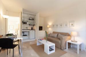 a living room with a couch and a table at Guesthouse Palma - Suite Arabella Apartment, Adults Only in Palma de Mallorca