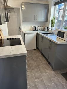 a kitchen with white cabinets and a counter top at 23 Horner Street York in York