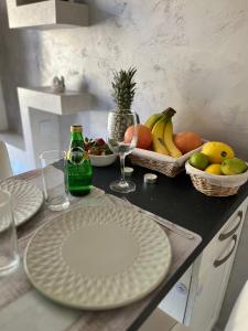 a table with plates and bowls of fruit on it at Old Town Stylish Flat in Center Plovdiv in Plovdiv