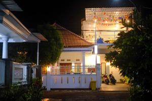 a house at night with motorcycles parked in front of it at ROOM Ijen Hostel in Banyuwangi