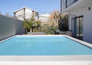 a swimming pool in the backyard of a house at Thyrso Village in Santo Tirso