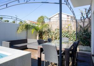 a patio with a table and chairs and a pool at Thyrso Village in Santo Tirso
