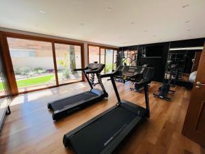 a gym with two treadmills and two exercise bikes at MRG - Bellagio Canela- 2 Suítes Próxima à Catedral de Pedra in Canela