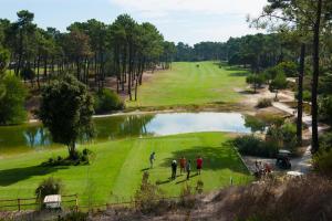 a group of people playing golf on a golf course at Apartment Anibal in Aroeira