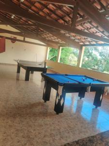 two pool tables in a large room withwindows at Casa muito espaçosa privativa com Piscina, Churrasqueira e área gourmet in Araruama