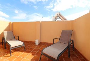 two chairs on a balcony with a roof at Casa Nayroa by Spainsunrentals 1019 in Nerja