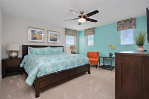 a bedroom with a bed and a ceiling fan at Serene Bliss at White Rose Villas in Davenport +45 photos