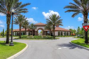 a road in front of a house with palm trees at Serene Bliss at White Rose Villas in Davenport