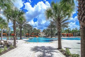 a swimming pool with palm trees and a resort at Serene Bliss at White Rose Villas in Davenport