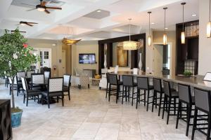 a dining room with a bar with black chairs at Serene Bliss at White Rose Villas in Davenport