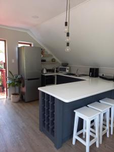 a kitchen with a white counter and a refrigerator at Forest & Pine in George