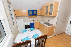 a small kitchen with a table and chairs in it at Apartman Lipa Centar Užica in Užice