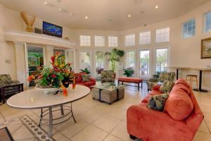 a large living room with red couches and a table at Butterfly Palm at Ellis Exclusive Villas in Kissimmee