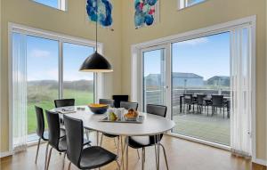 スナーヴィグにあるBeautiful Home In Ringkbing With House A Panoramic Viewのダイニングルーム(白いテーブル、椅子付)