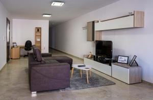 a living room with a couch and a tv at Modern 3 bedroom Apartment in Luqa (Sleeps 6) in Luqa