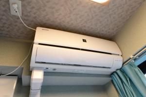 a computer printer in a corner of a room at Jing House akihabara Ryokan - Vacation STAY 11566v in Tokyo +8 photos