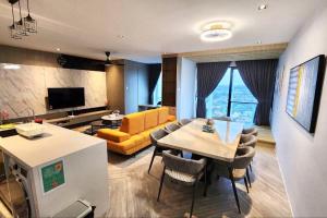 a living room with a table and a yellow couch at Lumi Tropicana, PJ-01. Golf view. in Petaling Jaya
