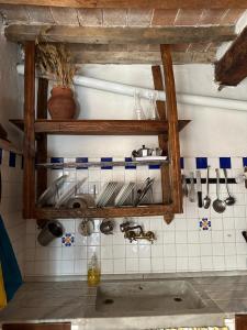 a kitchen with a sink and utensils on a wall at La casa nel Castello in Canneto