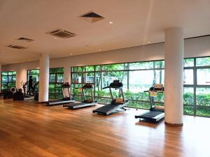 a gym with a bunch of treadmills in a room at Deluxe Sunrise Suite 3 bedroom Loft B side seaview above Imago Shopping Mall in Kota Kinabalu