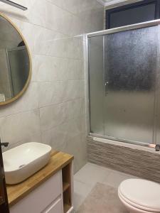 a bathroom with a toilet and a sink and a mirror at Atlantis-Alterah in Ramallah