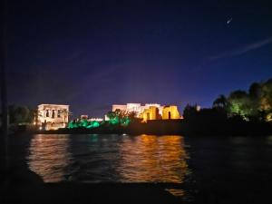a view of a city from the water at night at Villa Misk in Aswan