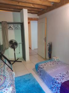 a bedroom with a bed and a room with a mirror at Un petit coin de Paradis in Deshaies