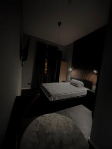 a dark room with two beds and a window at Le Neuf Residence in Frankfurt