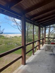 a porch with a fence and a view of the ocean at Vista da Guarita in Torres