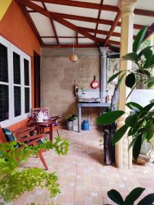 an outdoor patio with a table and a grill at Mandara Rest in Hikkaduwa