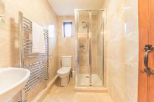 a bathroom with a shower and a toilet and a sink at Tower Cottage Far Sawrey Windermere in Far Sawrey +18 photos