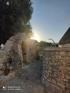 an entrance to a stone building with a stone wall at Masseria Calò in Monopoli